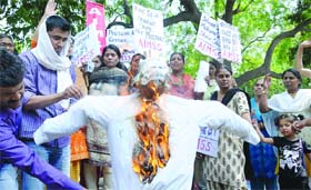 Women rights groups burn an effigy of Samajwadi Party chief Mulayam Singh Yadav during a protest against his remarks on rape that 'Boys are boys and they do commit mistakes and they should not be hanged', at Jantar Mantar in New Delhi on Saturday.