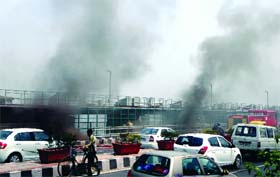 Fire personnel try to douse the flames after an electrical wire catches fire at the Yamuna bridge in New Delhi on Saturday.