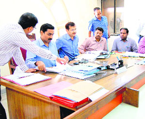 District election officials scrutinise nomination forms of aspiring candidates on the first day of the seven-day nomination process in Haridwar on Saturday.
