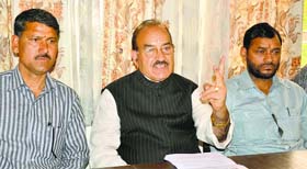Health Minister Kaul Singh Thakur addresses a press conference in Mandi on Sunday.