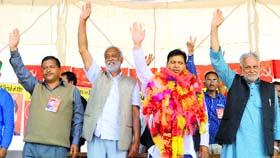 CPM candidate Kushal Bhardwaj and other leaders of the party wave at a crowd in Mandi on Saturday.