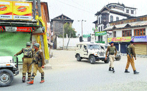 Paramilitary personnel patrol during restrictions in Srinagar on Saturday.
