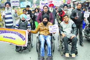 Disability rights activists march against the delay in introducing the Rights to Persons with Disabilities Bill