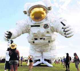 The Escape Velocity moving sculpture by artist group Poetic Kinetics looms over Coachella festival goers on the first day of the 2014 Coachella Music and Arts Festival in Indio, Calif