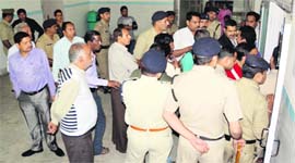 Police personnel and family members of the deceased at Coronation Hospital in Dehradun on Sunday.