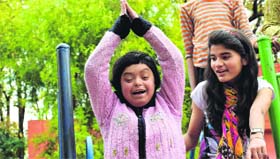 A volunteer of MAD with a resident of Raphael Home in Dehradun on Sunday.