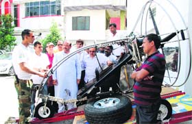 An expert explains the functioning of a paramotor trike to Congress leaders in Dehradun.