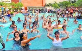 People participate in a summer pool party at a mall in Gurgaon on Sunday
