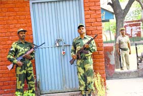Standing guard: Security personnel outside EVMs kept in a strongroom at CR Polytechnic in Rohtak on Saturday