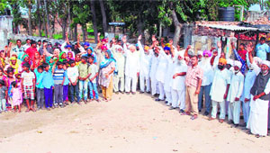Residents of Phulewal village shout slogans and demand the opening of Government Primary School in their locality in Jalandhar on Sunday.