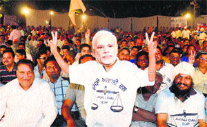 A SAD worker wearing the mask of Narendra Modi at a rally in Jalandhar.