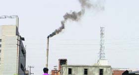 Smoke billows out of a chimney of a factory in Ludhiana.
