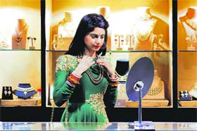A woman tries on a necklace at an exhibition in Ludhiana.
