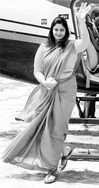 Actress and Congress candidate from Meerut Nagma waves to her supporters in Pilibhit on Sunday.