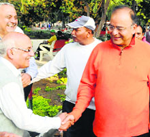 BJP candidate Arun Jaitley shakes hands with a morning walker at Company Bagh in Amritsar.