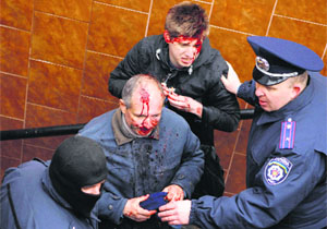 Interior Ministry members help men, who were injured in clashes between pro-Russian and pro-Ukrainian supporters during their rallies in Kharkiv on Sunday.