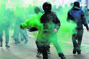 An activist holds a flare during an anti-austerity protest in Rome.