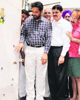 Congress leader Karamjit Rintu shows bullet marks on the wall of  his election office in Amritsar on Monday