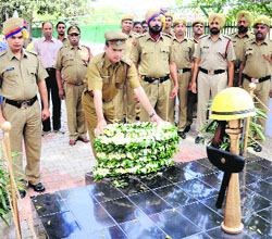 An official of the Fire Department lays a wreath at a memorial on Fire Safety Day at Sector 17, Chandigarh, on Monday. 