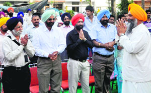 Residents greet SAD candidate Prem Singh Chandumajra at Phase XI in Mohali.