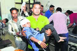 A child, who sustained injuries in the road mishap near Kharka Kalan village, undergoes treatment at the Civil Hospital in Jalandhar on Monday. Tribune Photo: Malkiat Singh