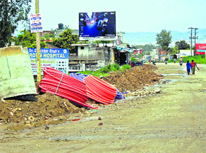 A telecom company digs up a road to lay cables in Jammu.
