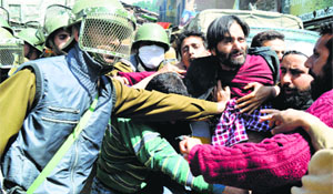 Policemen detain JKLF chairman Yasin Malik along with his party activists in Anantnag district on Monday.