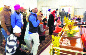 Devotees offer prayers at Gurdwara Chatti Padshahi at Raniwari in Srinagar on Monday.