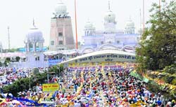 Devotees throng Gurdwara Damdama Sahib in Talwandi Sabo on Baisakhi on Monday. Tribune photo