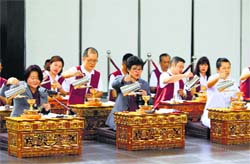 Buddhist pastors and devotees perform 'Golden Drink' as they offer prayers for passengers onboard the missing Malaysia Airlines Flight 370 at Kechara Forest Retreat in Bentong, outside Kuala Lumpur, Malaysia, on Sunday. After a week of optimism over four underwater signals believed to be coming from the missing Malaysian plane, the sea has gone quiet. PTI