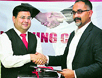 Dr Anshu Kataria, Chairman of Aryans Group (left), shakes hands with Mohd Suhail, North Head, Pearson Higher Education, in Chandigarh on Tuesday