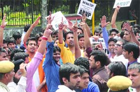 ABVP activists and DUSU members shout slogans during the protest at the North Campus of Delhi University in New Delhi on Tuesday