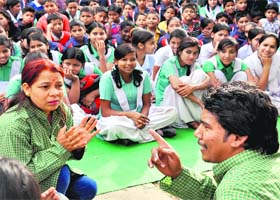 Spreading message: School girls enjoy a street play at Gandhi Park in Dehradun on Tuesday