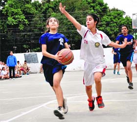 Aiming high: Girls in action during the District Junior Basketball Tournament at Doon International School in Dehradun on Tuesday