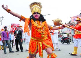 Devotion: An artiste dressed like Lord Hanuman, performs during a rally at Clock Tower in Dehradun on Tuesday