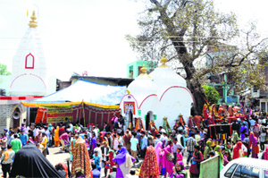People throng the Baisakhi Mela at Rewalsar in Mandi on Tuesday.