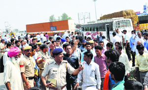 Police personnel try to pacify the protesters in Karnal on Tuesday.