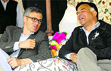 Chief Minister Omar Abdullah chats with National Conference candidate for the Anantnag constituency Mehboob Beig during a rally in Pulwama district on Tuesday