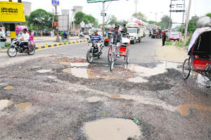 A damaged portion of the GT road near the Rose Garden due to leakage in a sewer pipeline Bathinda on Wednesday.