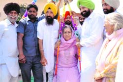 Congress candidate Ambika Soni being weighed against laddoos during an election campaign at Landran village in Mohali. A Tribune photograph