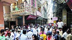 People gathered outside the house of Nawab, who was found murdered in East Delhi on Wednesday