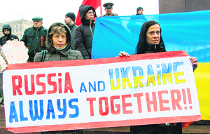 Pro-Russian protesters hold a placard as they take part in a pro-Russian rally in the eastern Ukrainian city of Kharkiv on April 13, 2014