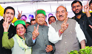 CM Virbhadra Singh, Pratibha Singh and Health Minister Kaul Singh Thakur make victory signs at a rally in Mandi on Wednesday.