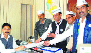 AAP candidate Jai Chand Thakur presents nomination documents to District Election Officer Devesh Kumar in Mandi on Wednesday.