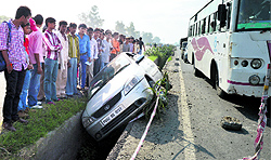 A car stuck in a storm-water drain on the NH-1 near Jalandhar bypass