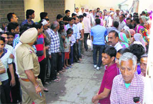 People gathered outside the house, where the bodies were found, in Abohar on Wednesday.