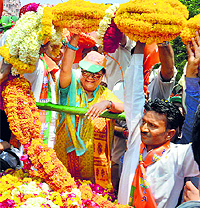 Rajasthan Chief Minister Vasundhara Raje waves to the crowd at a rally
