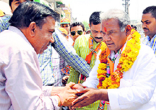 BJPs Anoop Misra Shakes hands with a supporter during a rally