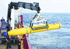 Crew aboard the Australian Defence Vessel Ocean Shield move the US Navys Bluefin-21 autonomous underwater vehicle into position for deployment in the southern Indian Ocean.