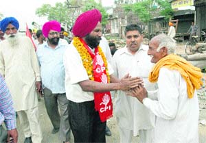 CPI candidate Amarjit Singh Asal (centre) greets supporters during an election campaign in Amritsar